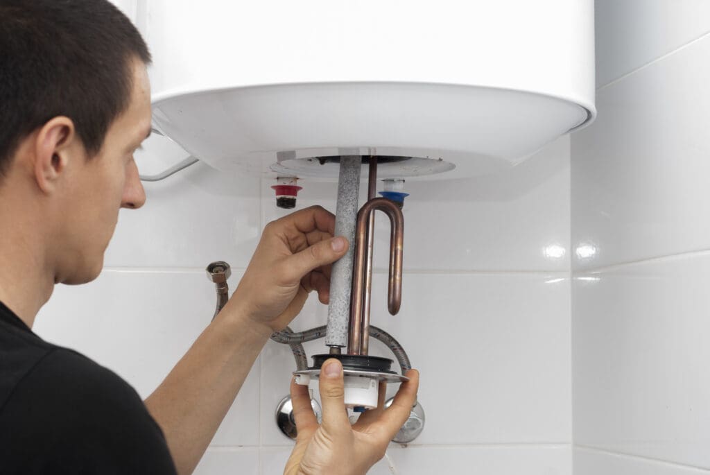 Plumber installs a new electric water heater