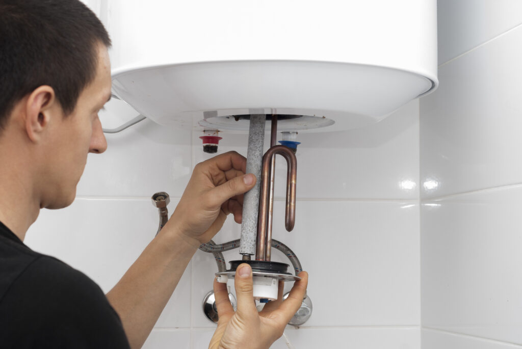 Plumber working on water heater repair